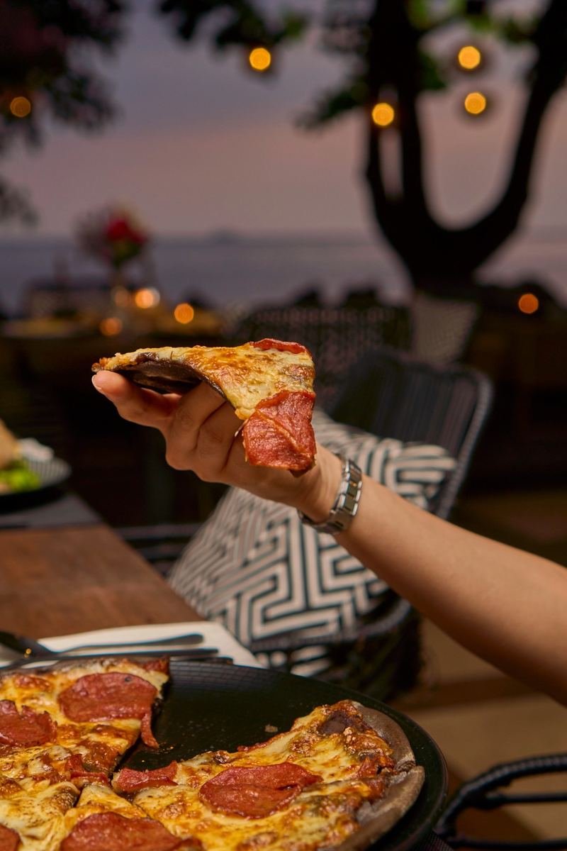 A slice of pepperoni pizza at dusk